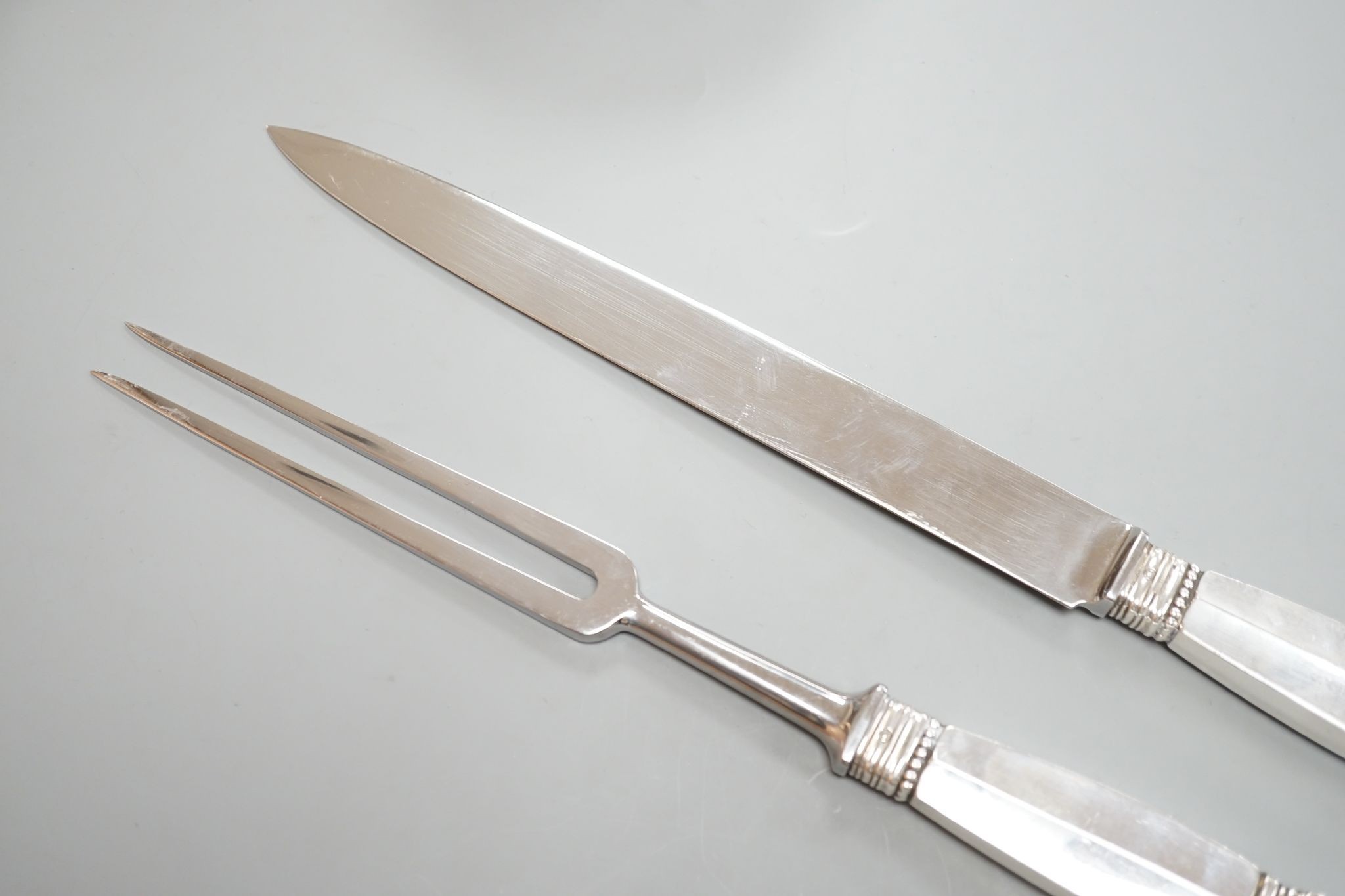 A pair of Georg Jensen sterling handled carving knife and fork, knife 34.4cm.